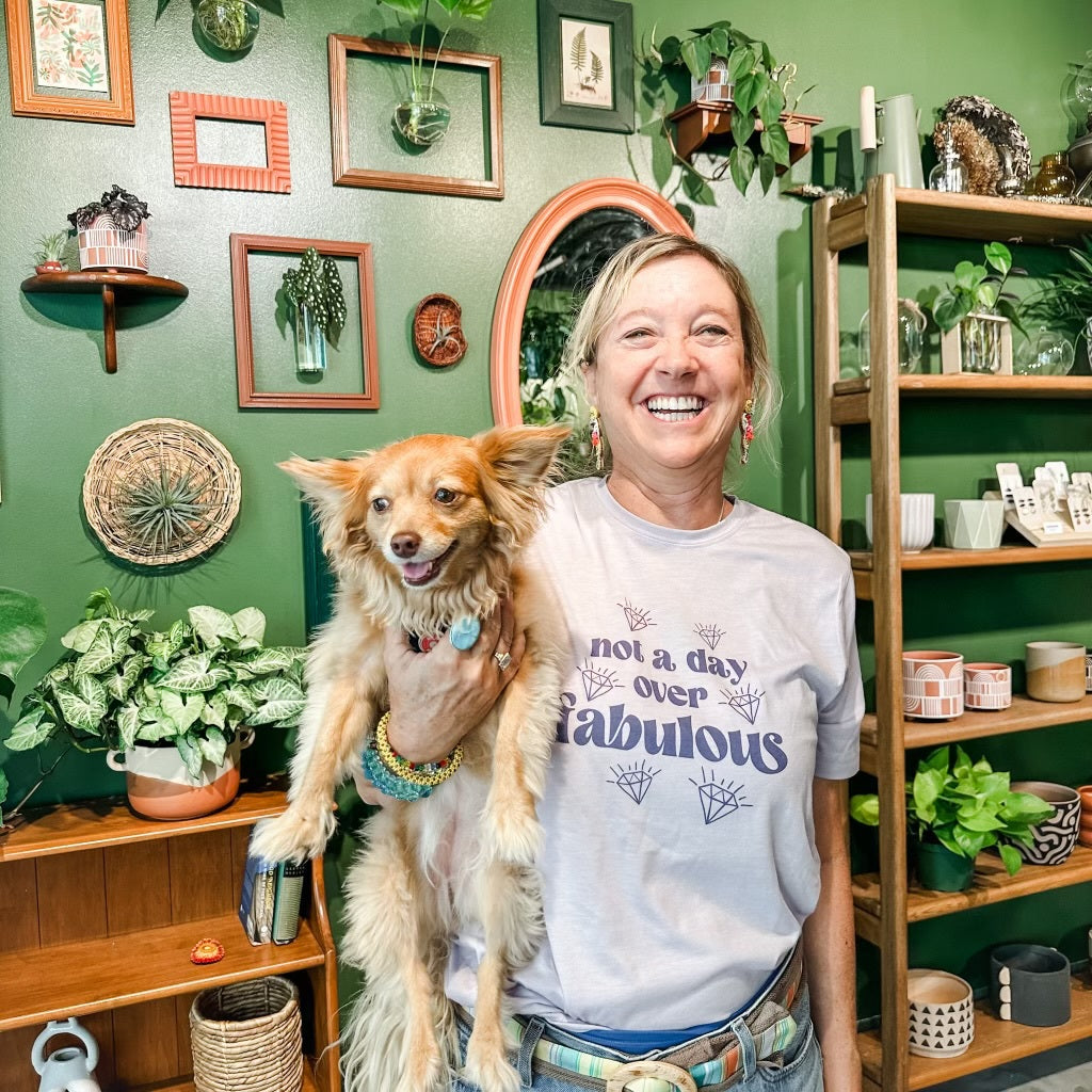 a woman holding a small dog in her arms