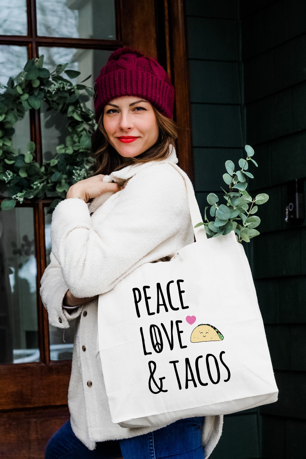 a woman carrying a bag that says peace love and tacos