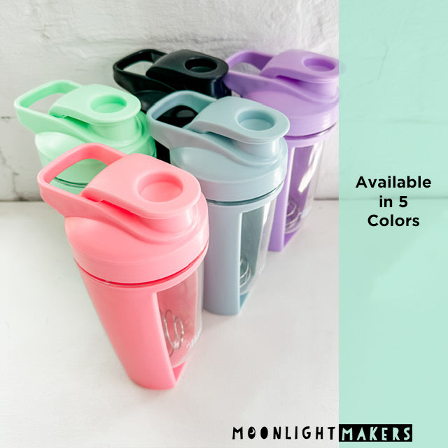 a group of four different colored cups sitting next to each other