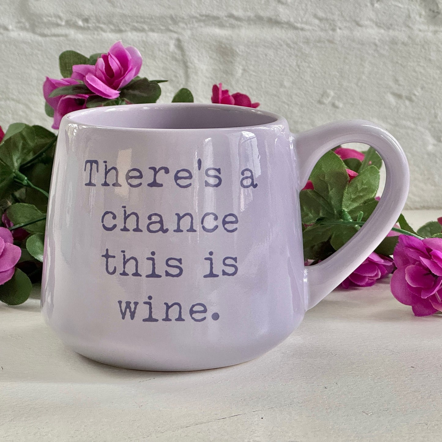 there is a purple coffee mug with words on it