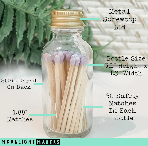 a glass jar filled with matches on top of a table