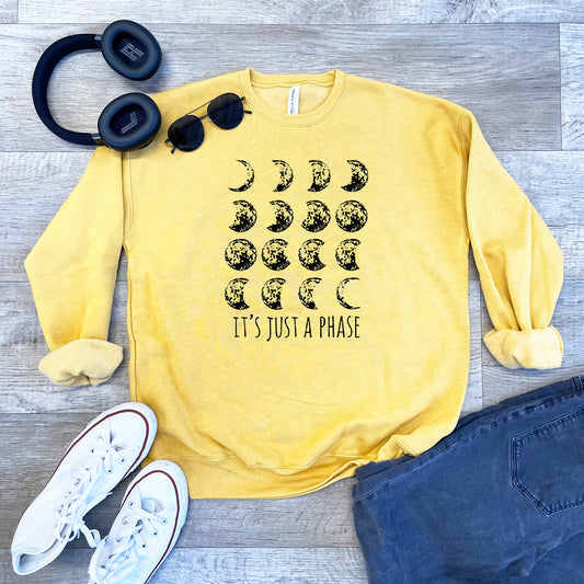 a yellow sweatshirt with the words it's just a phase printed on it