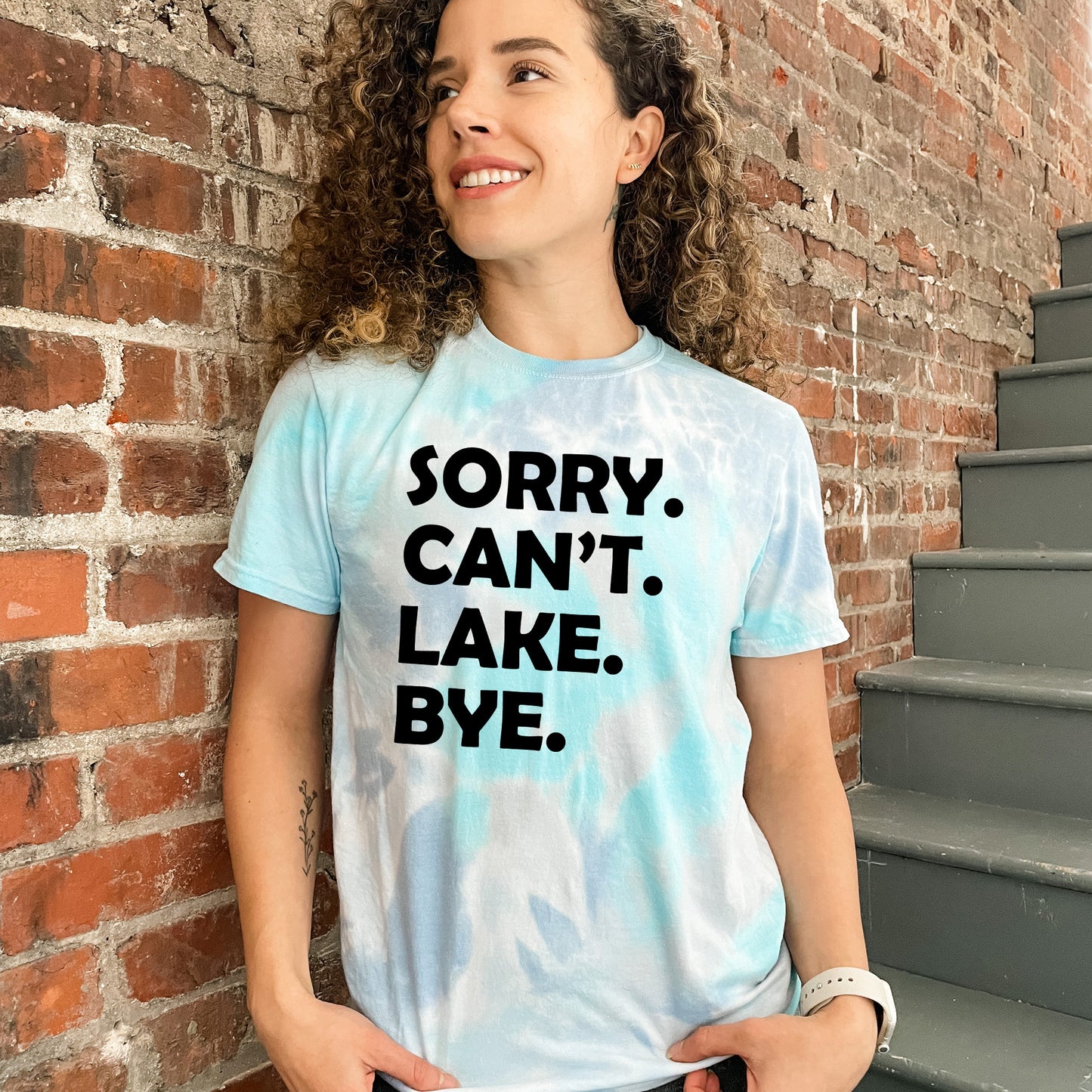 a woman wearing a t - shirt that says sorry, can't lake bye