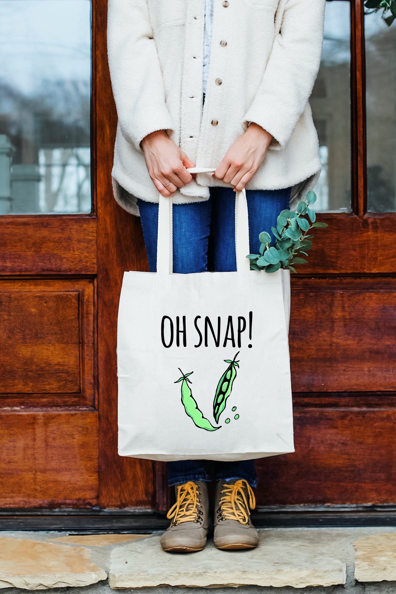 a woman holding a bag that says oh snap