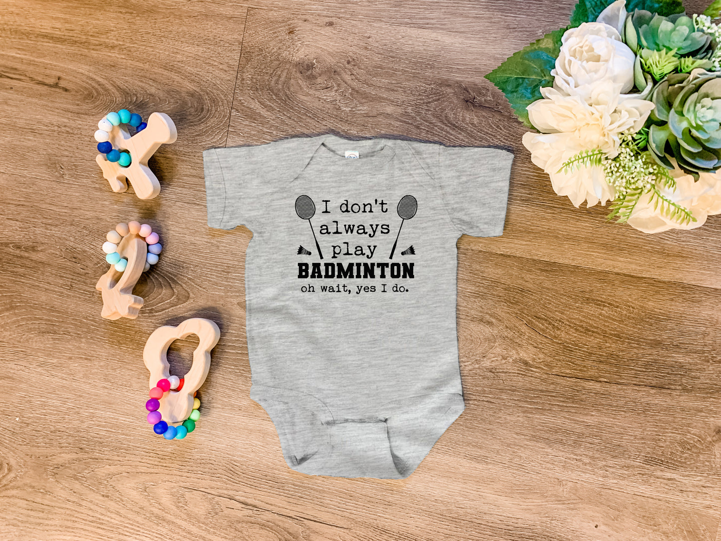 a baby bodysuit that says i don't always play badminton