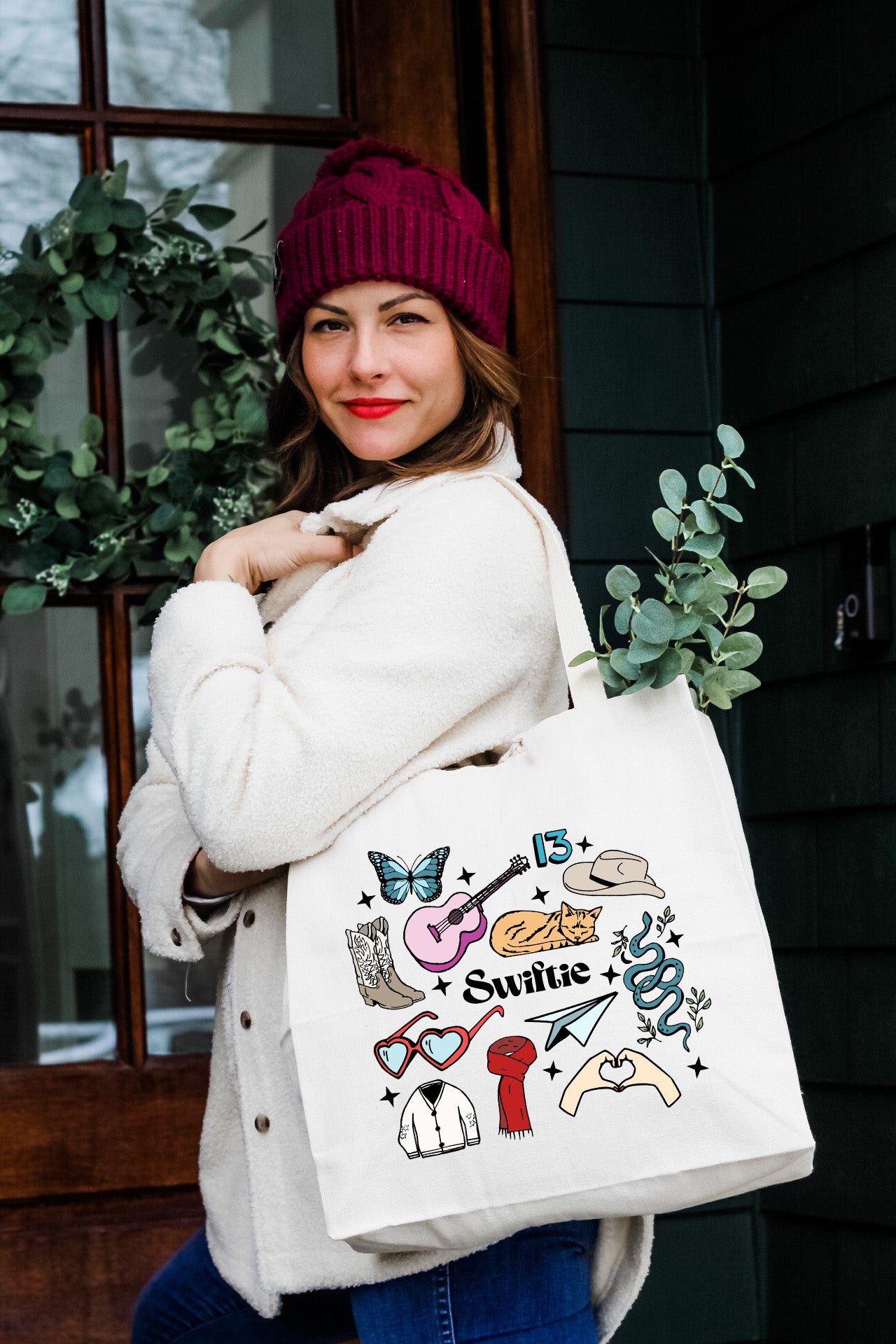 a woman carrying a white tote bag