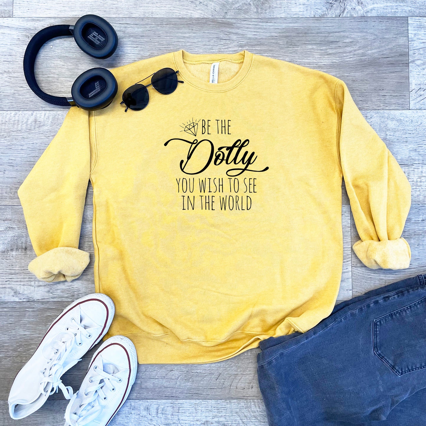 a yellow sweatshirt that says, be the do you wish to see in the world