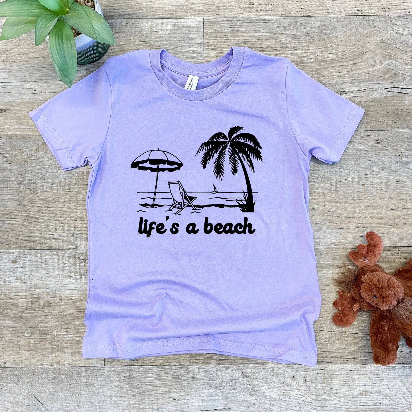 a t - shirt with a picture of a beach umbrella and a chair