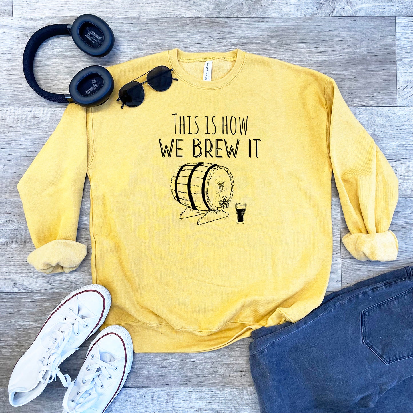 a yellow sweatshirt with a coffee mug and headphones