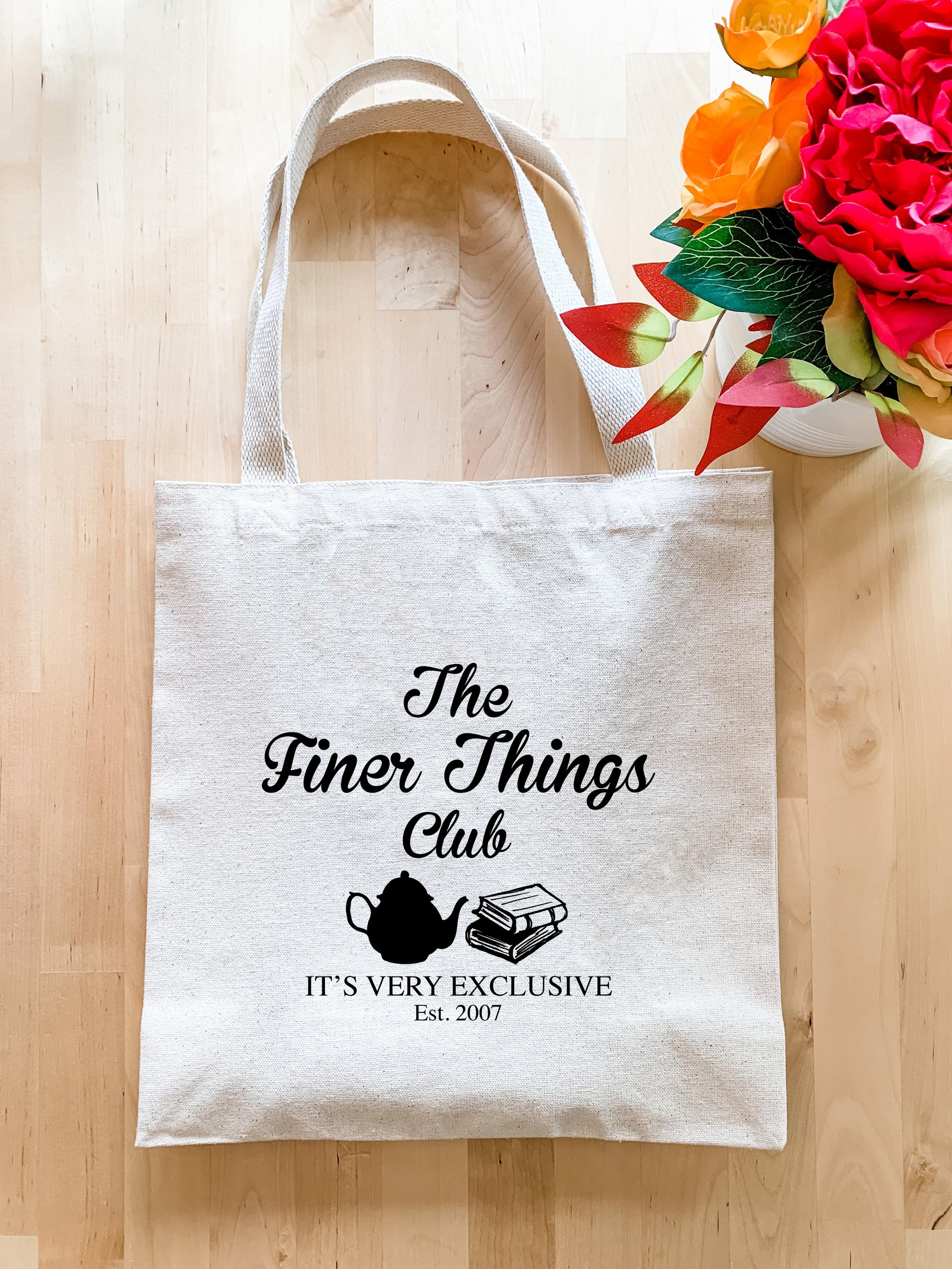 a tote bag sitting on top of a wooden floor