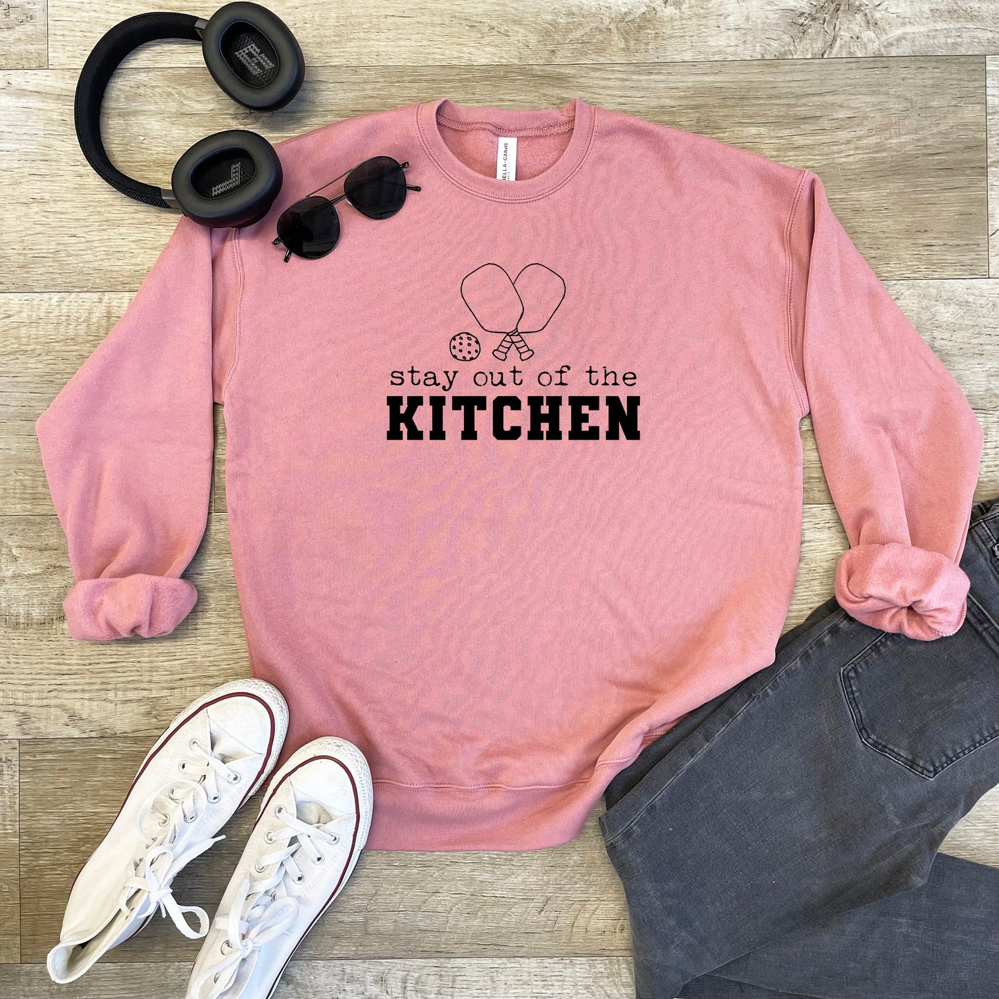 a pink sweatshirt that says stay out of the kitchen