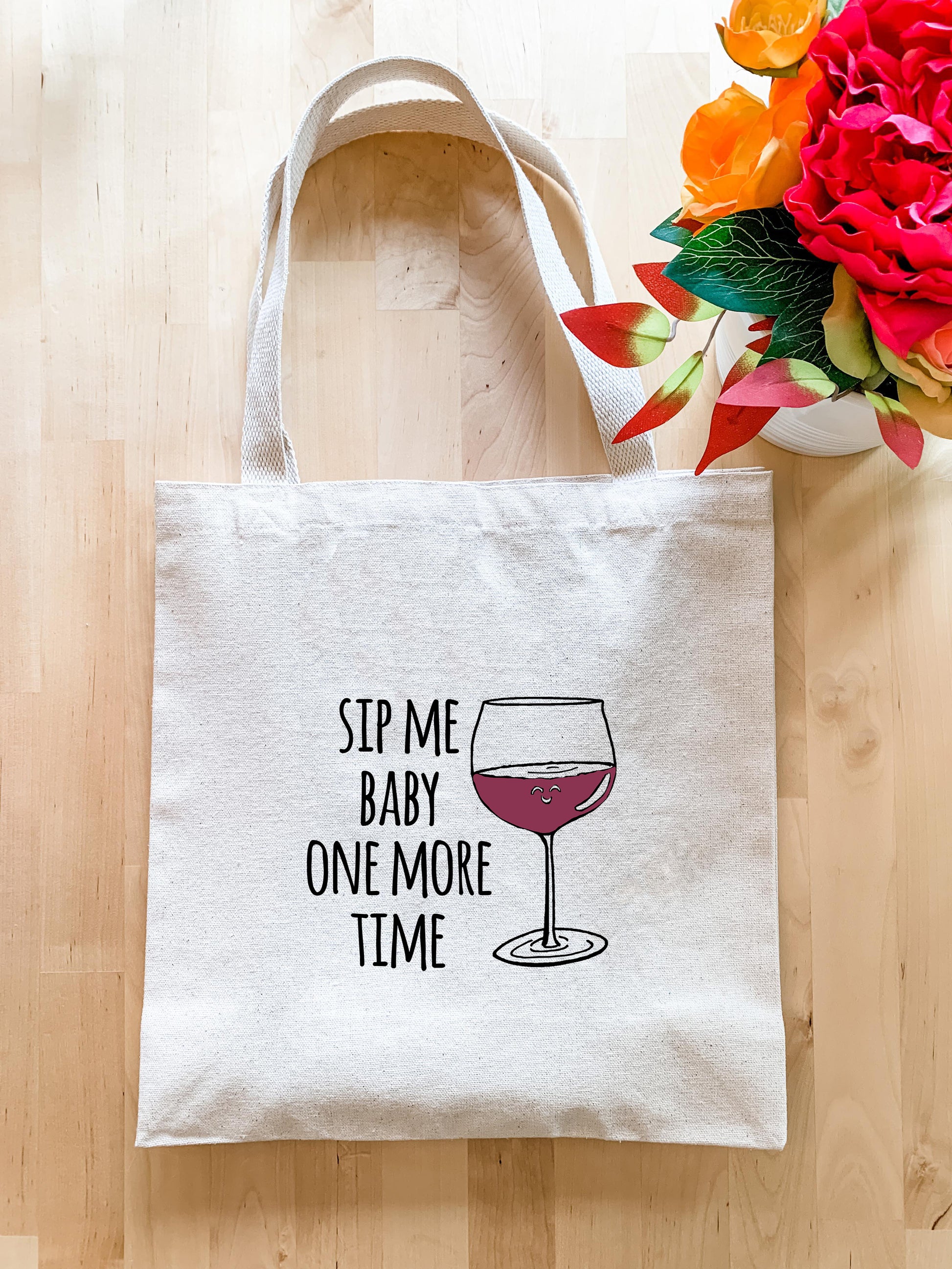 a tote bag with a glass of wine on it