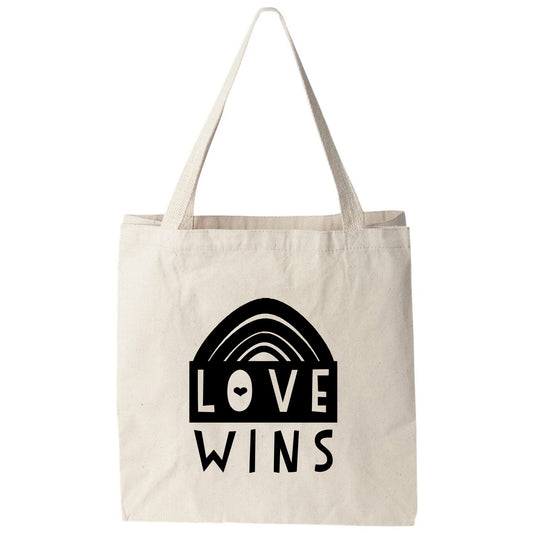 a tote bag with the words love wins on it