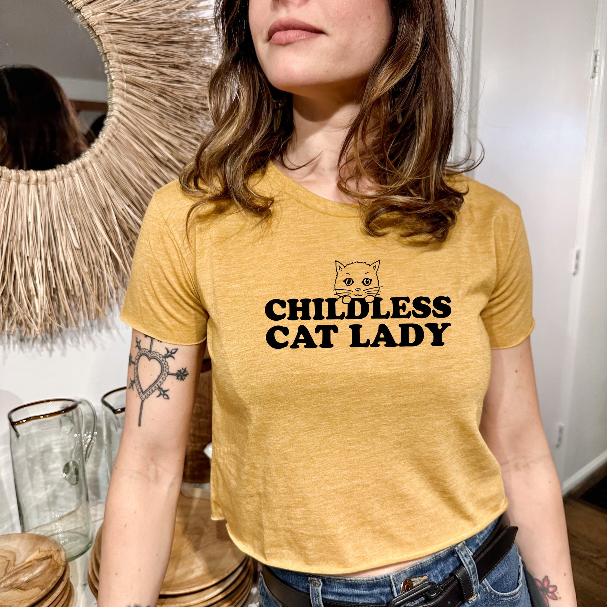 a woman wearing a yellow shirt with a cat lady on it