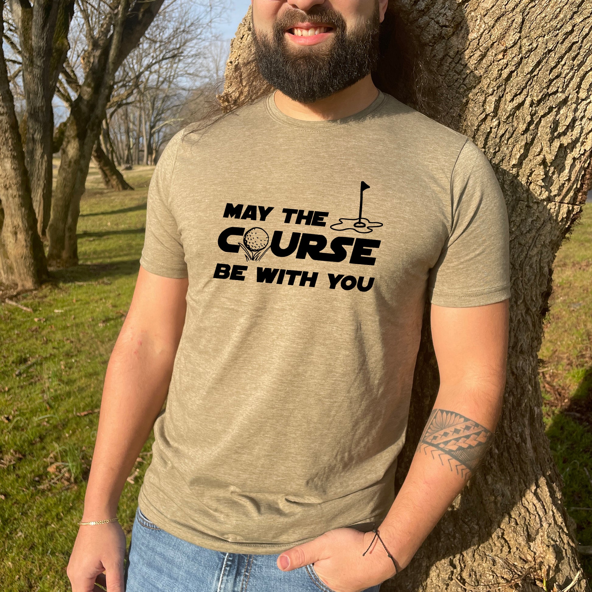 a man wearing a t - shirt that says may the course be with you