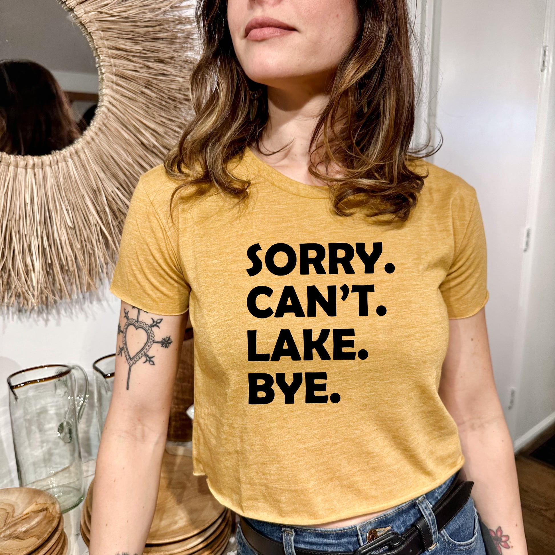 a woman wearing a t - shirt that says sorry, can't lake bye