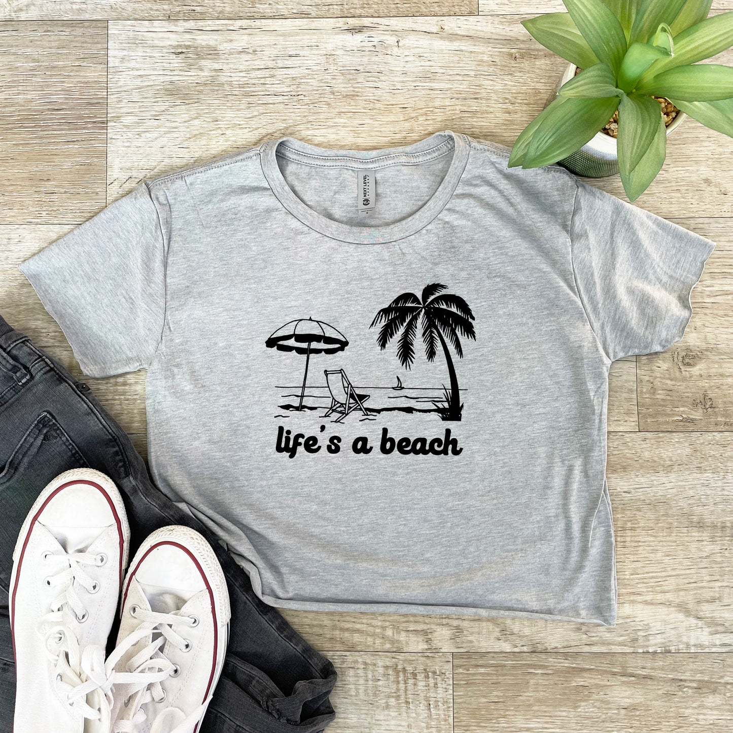 a t - shirt that says life's a beach with a beach umbrella and