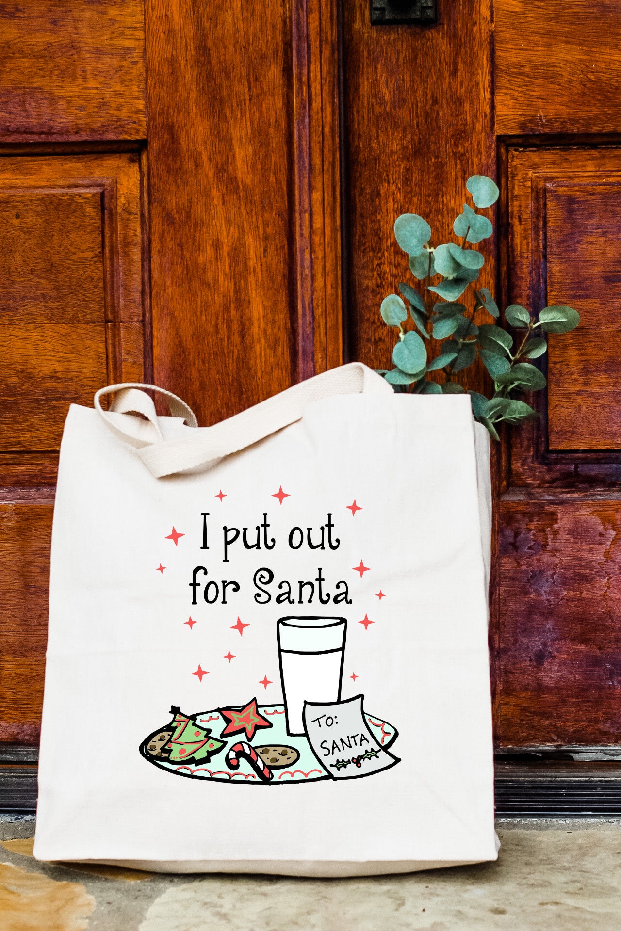 a white tote bag with a picture of a glass of milk