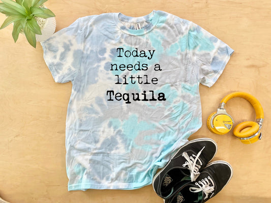 a shirt that says today needs a little tequila next to a pair of headphones