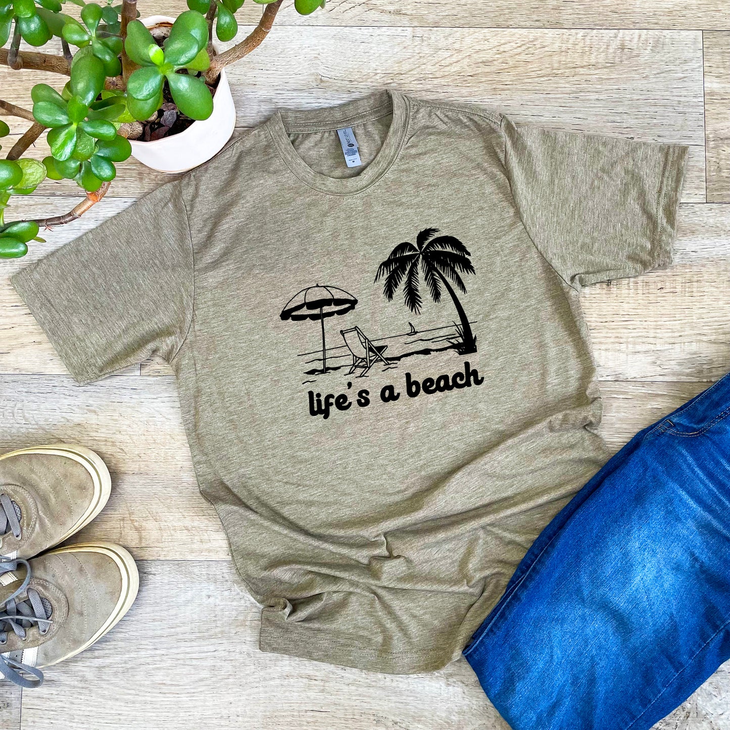 a t - shirt that says life's a beach with a palm tree and