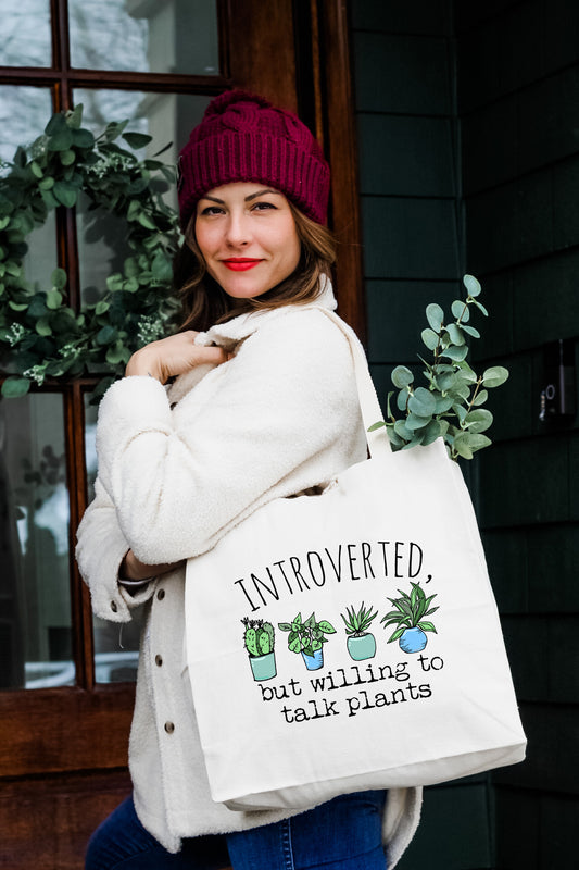 a woman carrying a white bag with plants on it