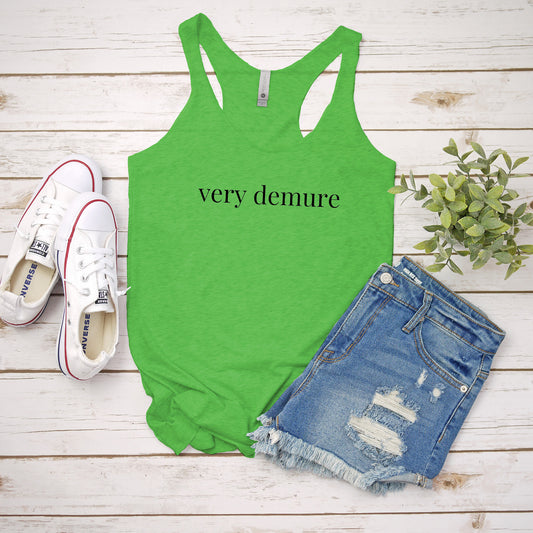 a green tank top that says very demure next to a pair of shorts