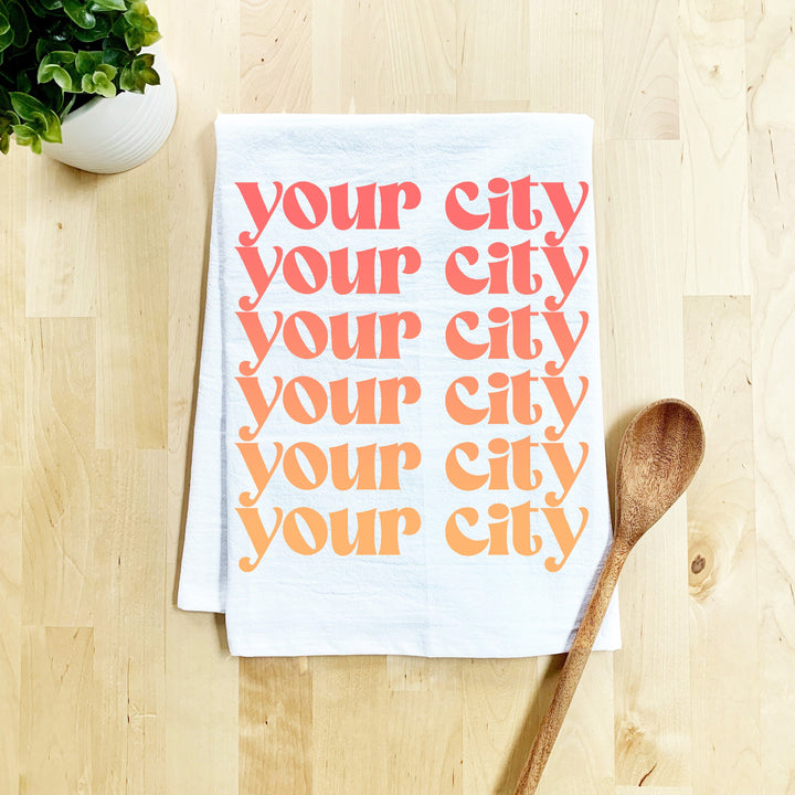 a tea towel with a spoon on a wooden table
