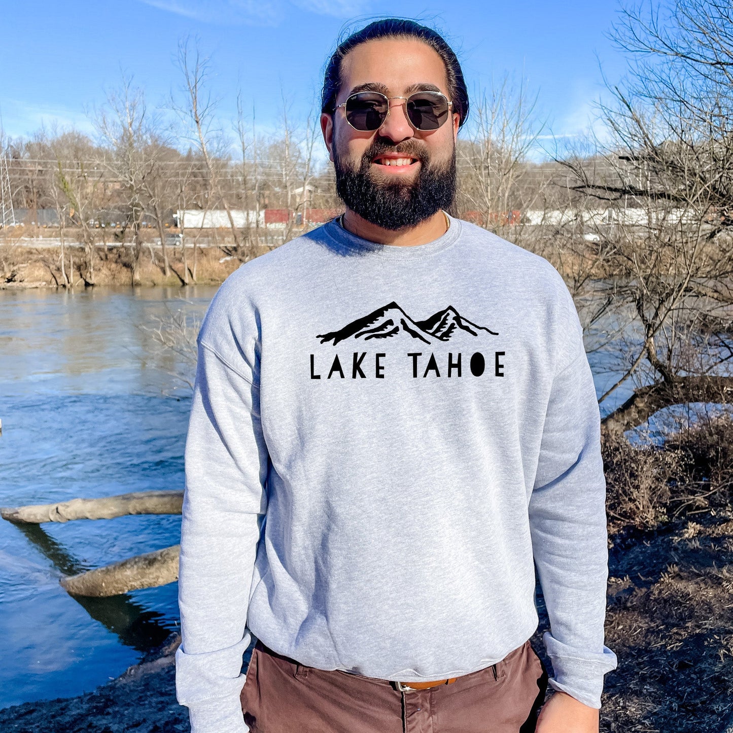 a man standing in front of a body of water