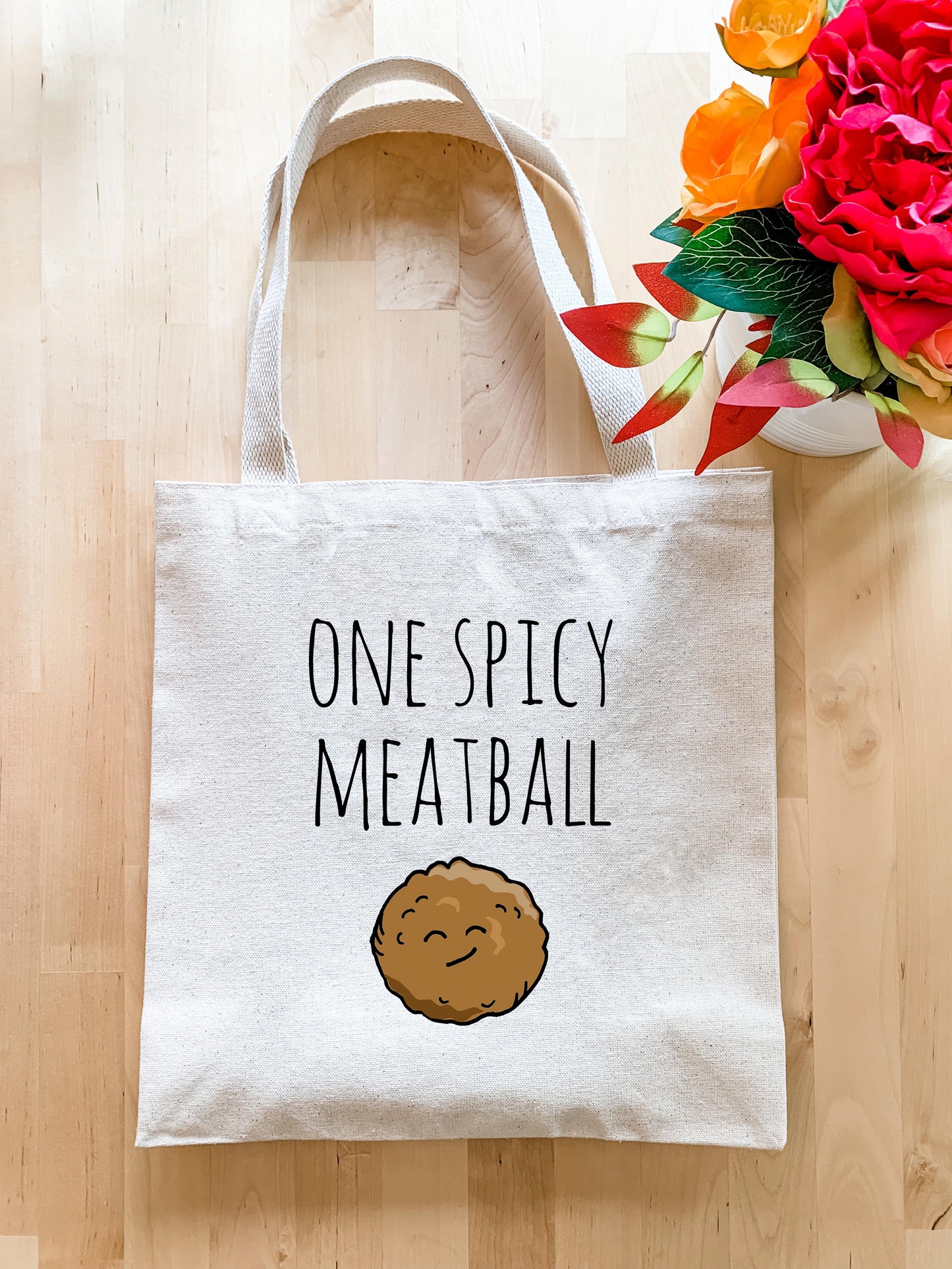 a tote bag that says one spicy meatball
