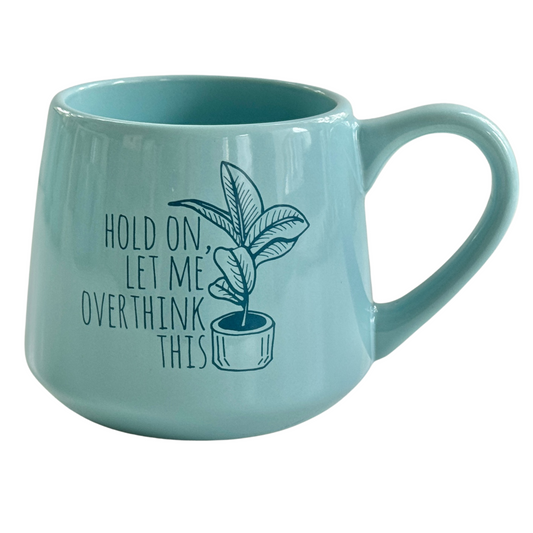 a blue coffee mug with a plant on it