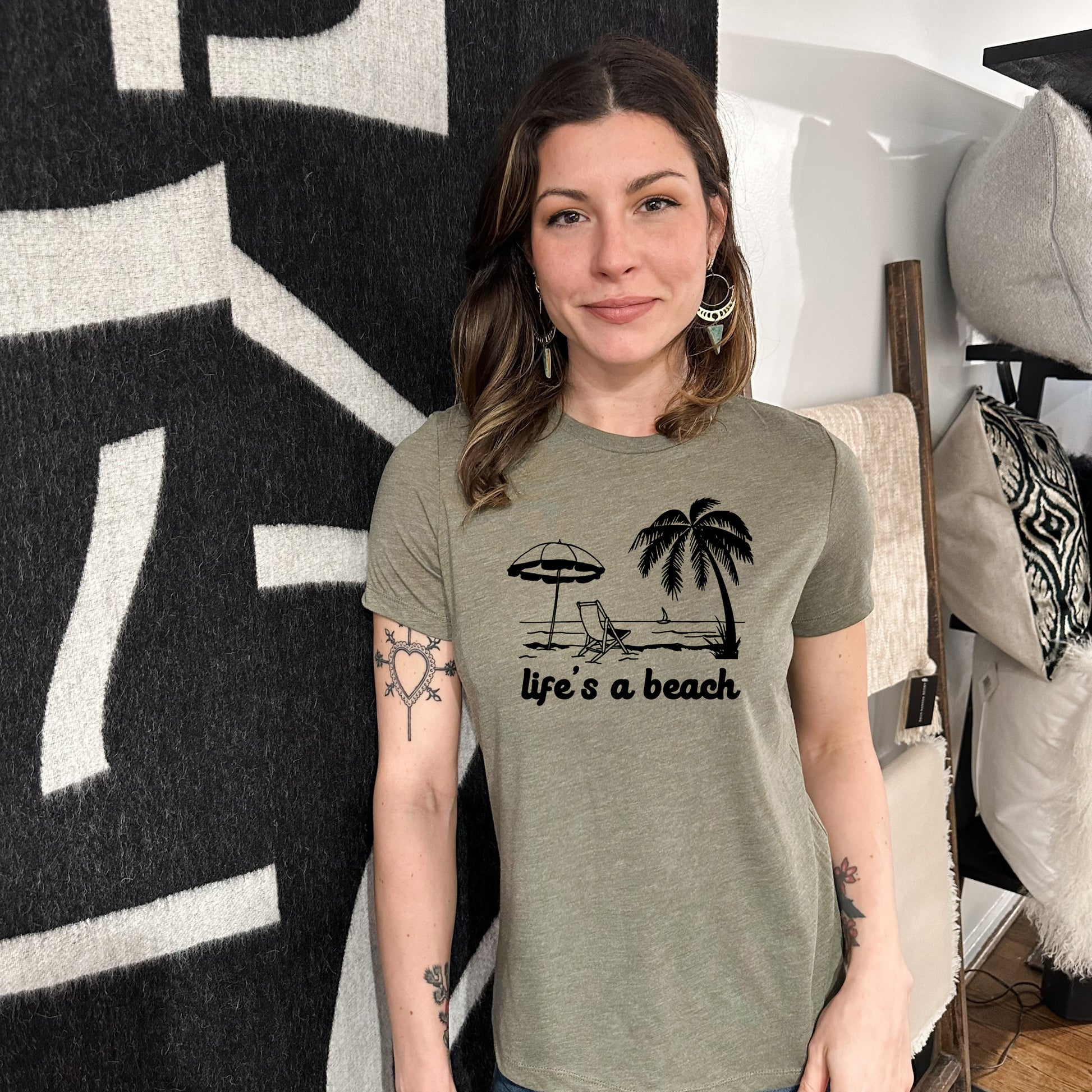 a woman wearing a t - shirt that says life's a beach