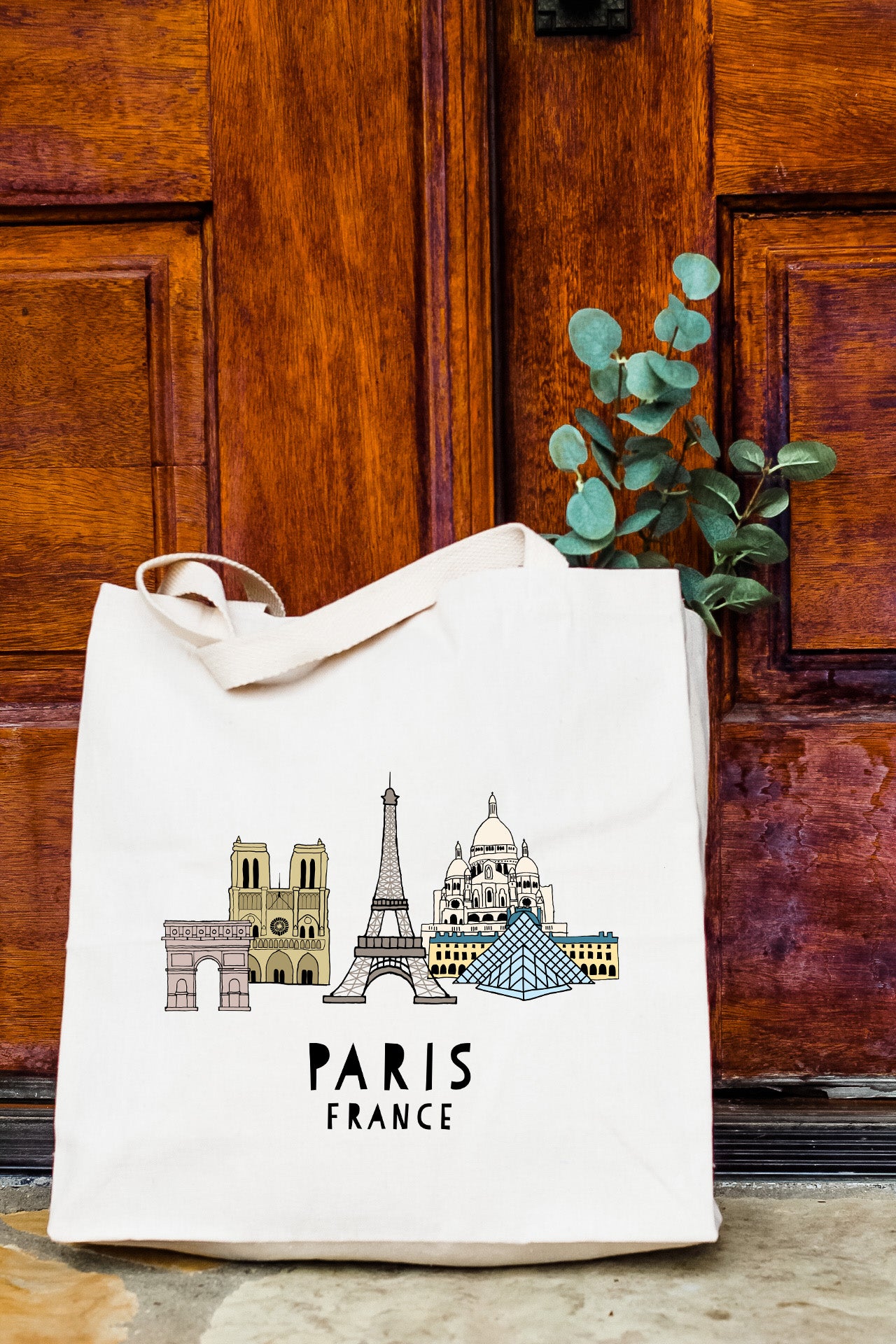 a white bag with a picture of the eiffel tower