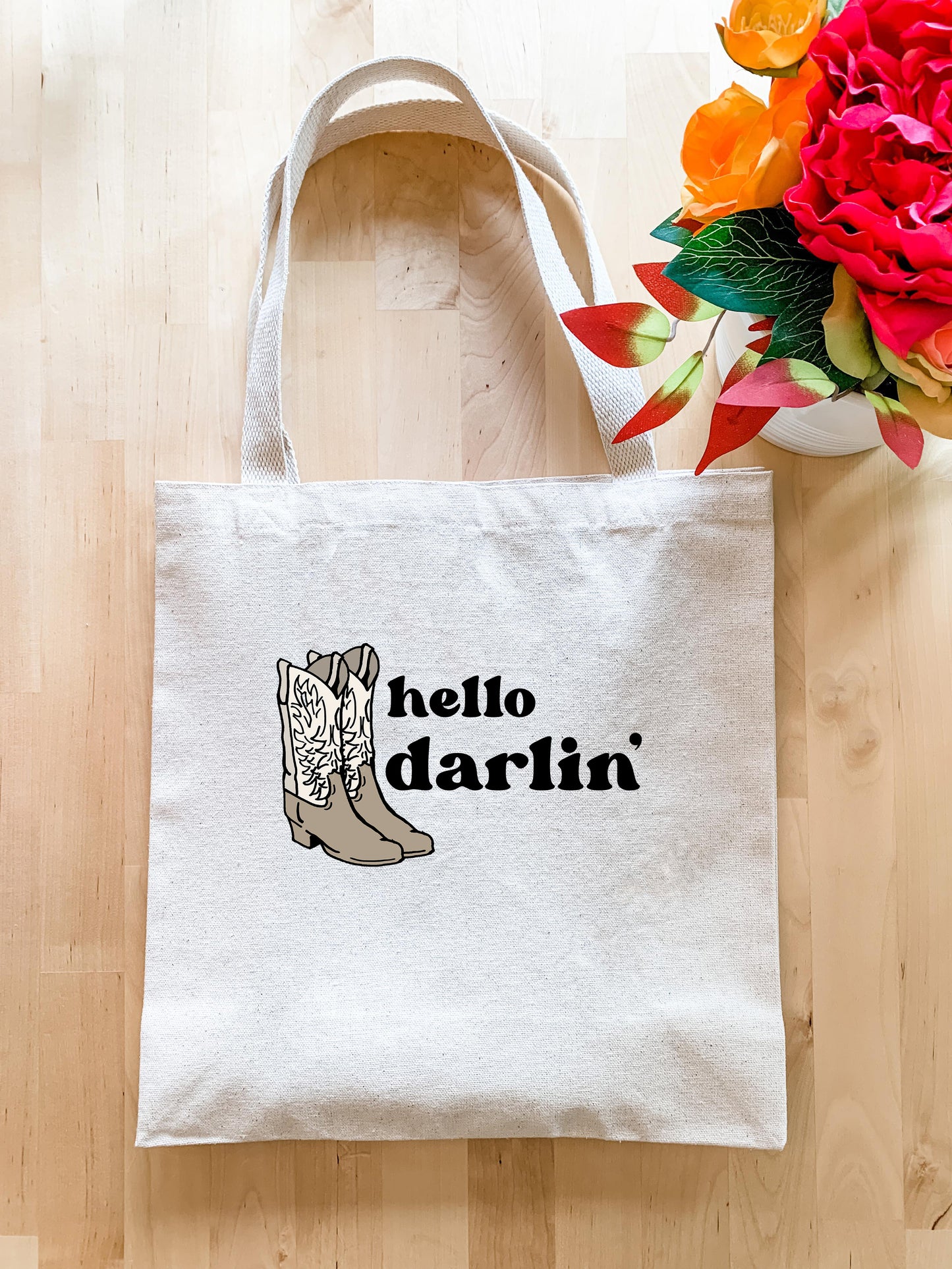 a white tote bag with a picture of a boot on it