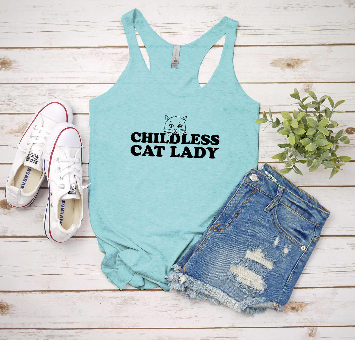 a tank top that says,'childless cat lady'next to a pair