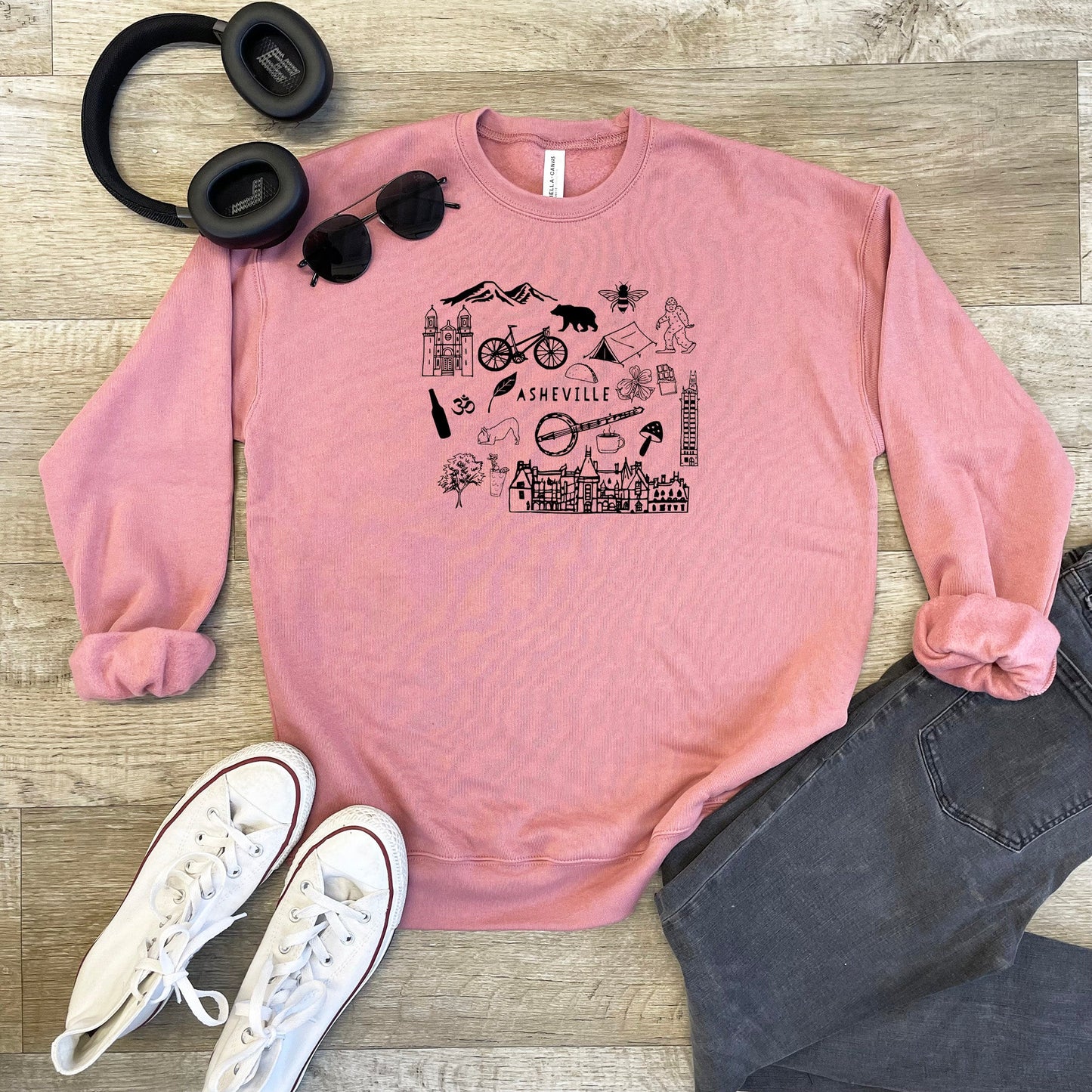 a pink sweatshirt with a picture of a woman's face and a pair of