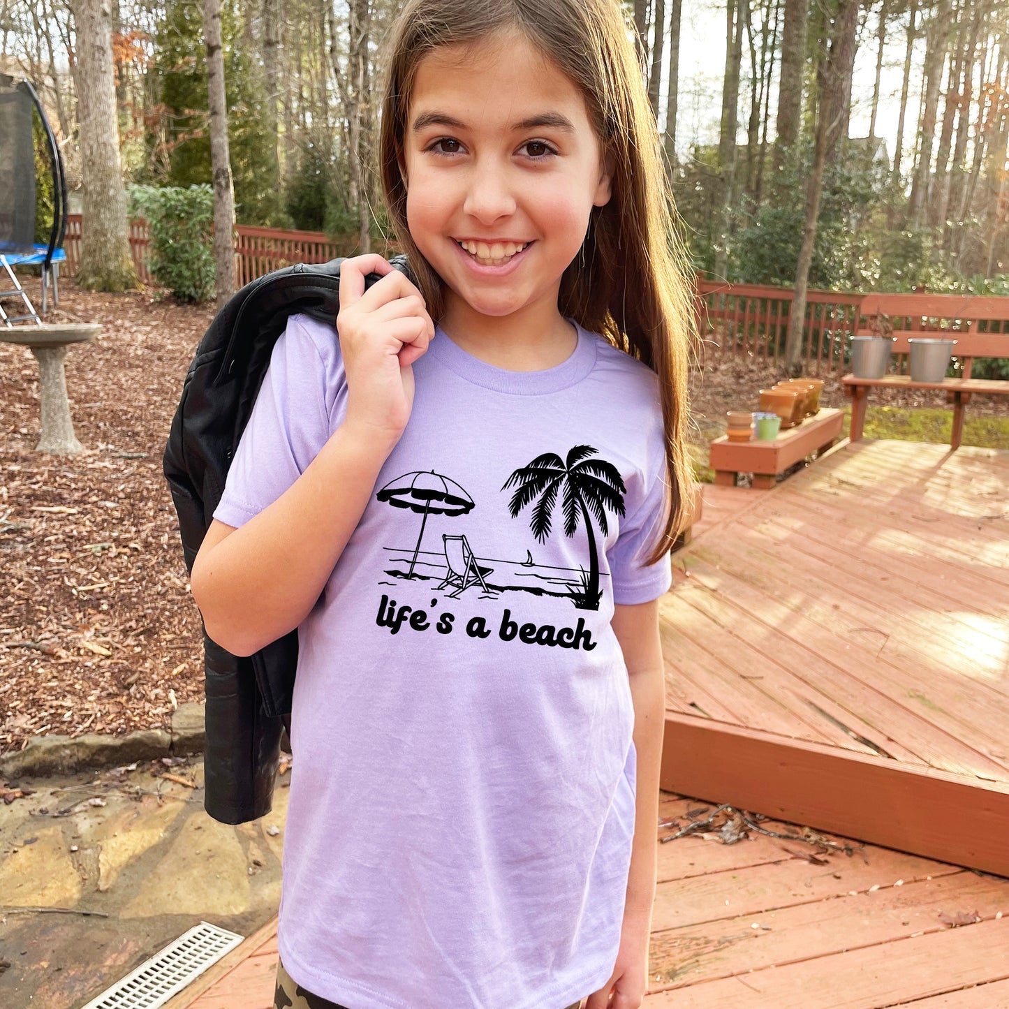 a girl with a backpack and a life's a beach t - shirt