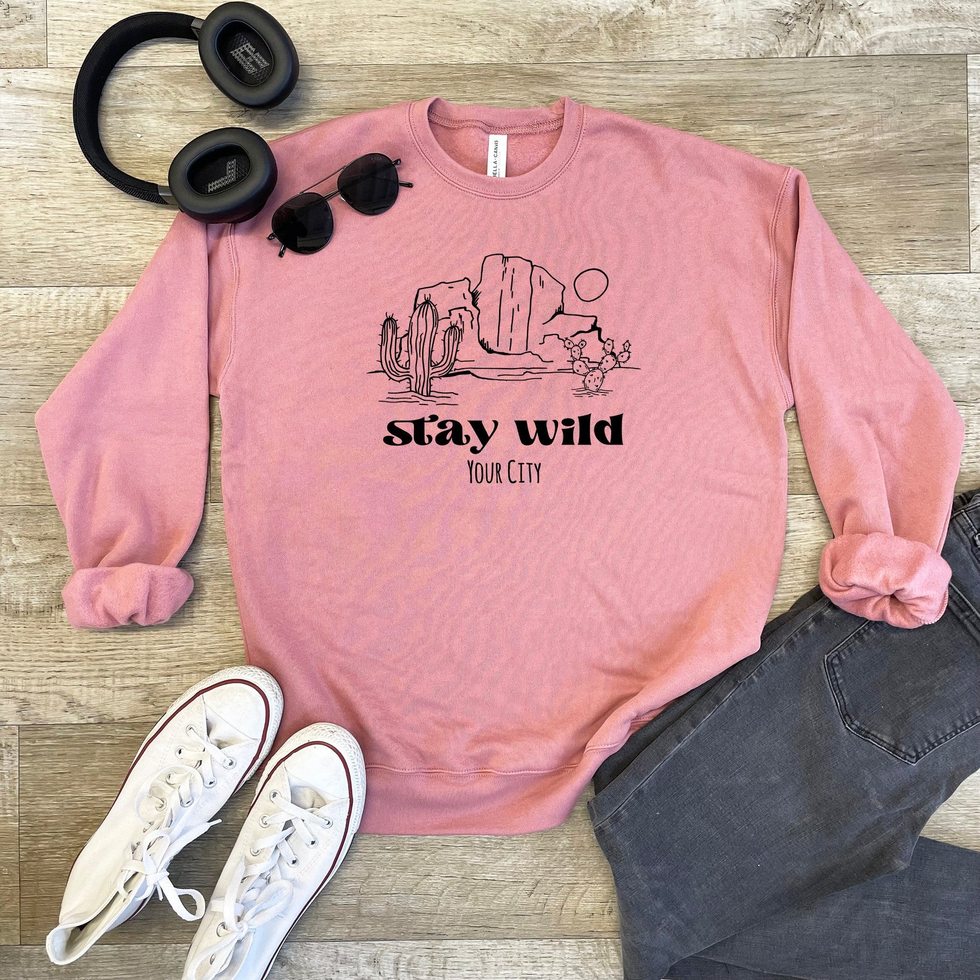 a pink sweatshirt with the words stay wild on it