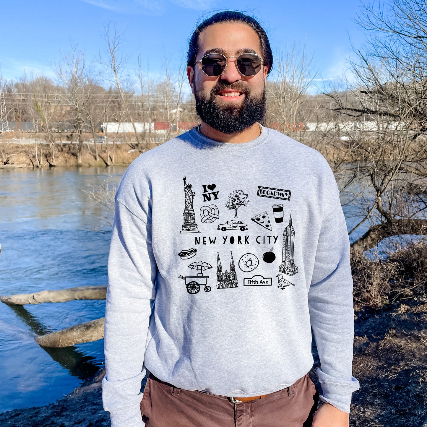 a man standing in front of a body of water