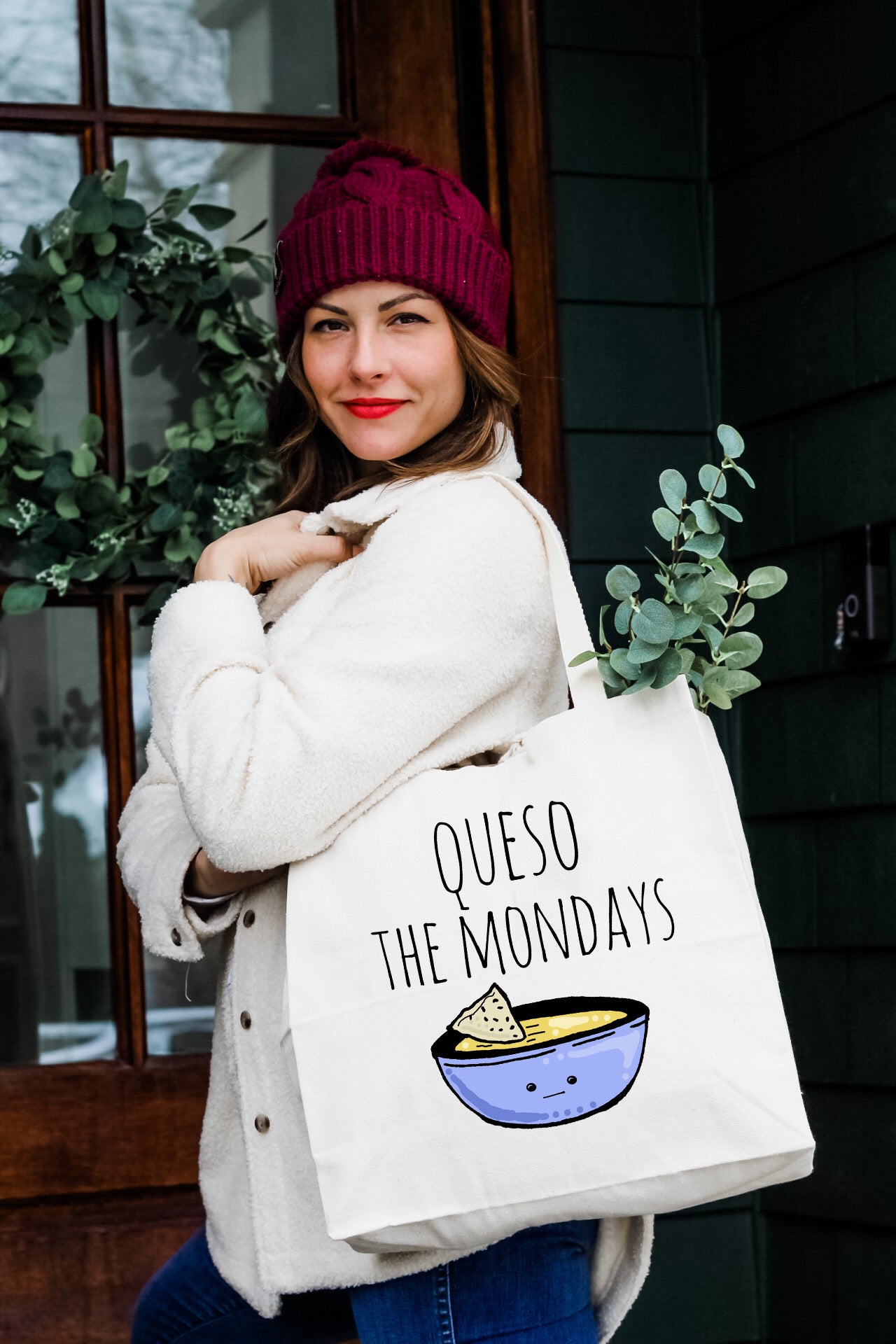 a woman carrying a bag that says queso the mondays