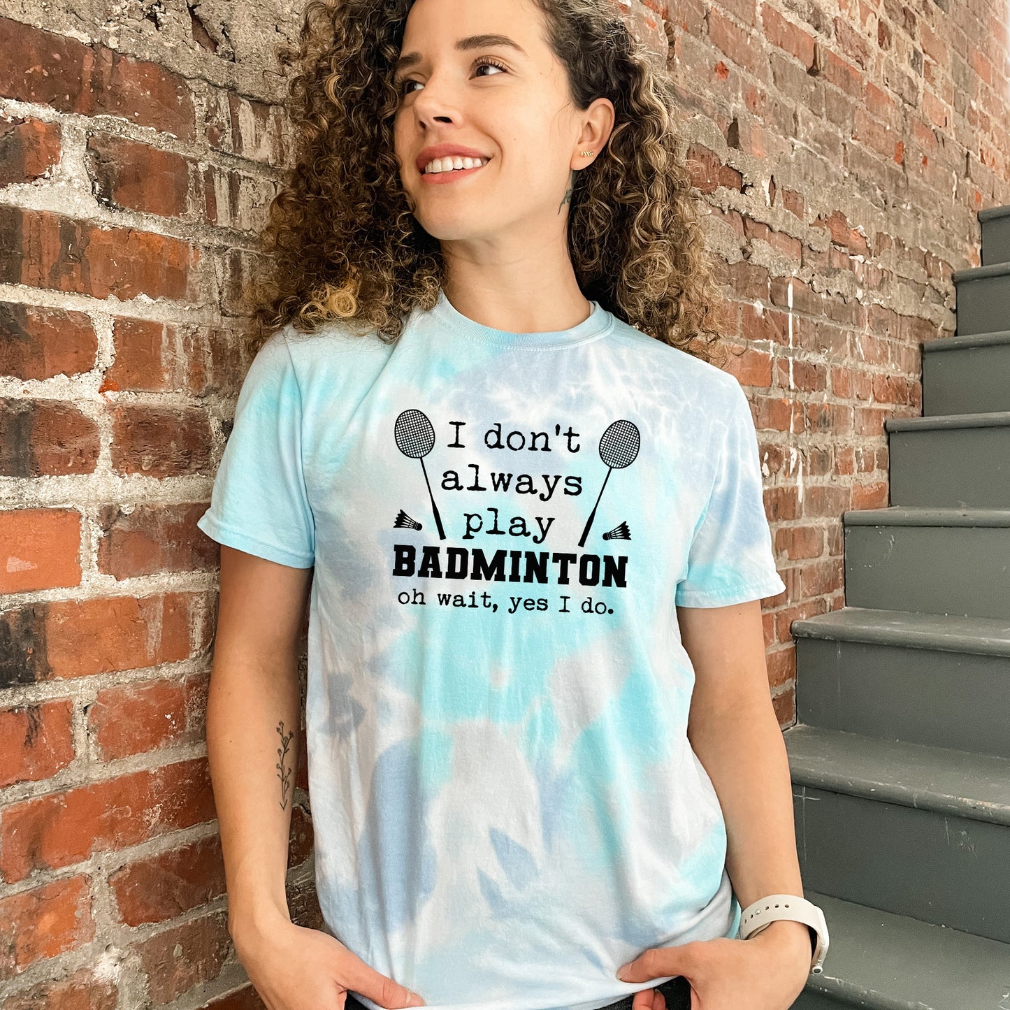 a woman standing in front of a brick wall