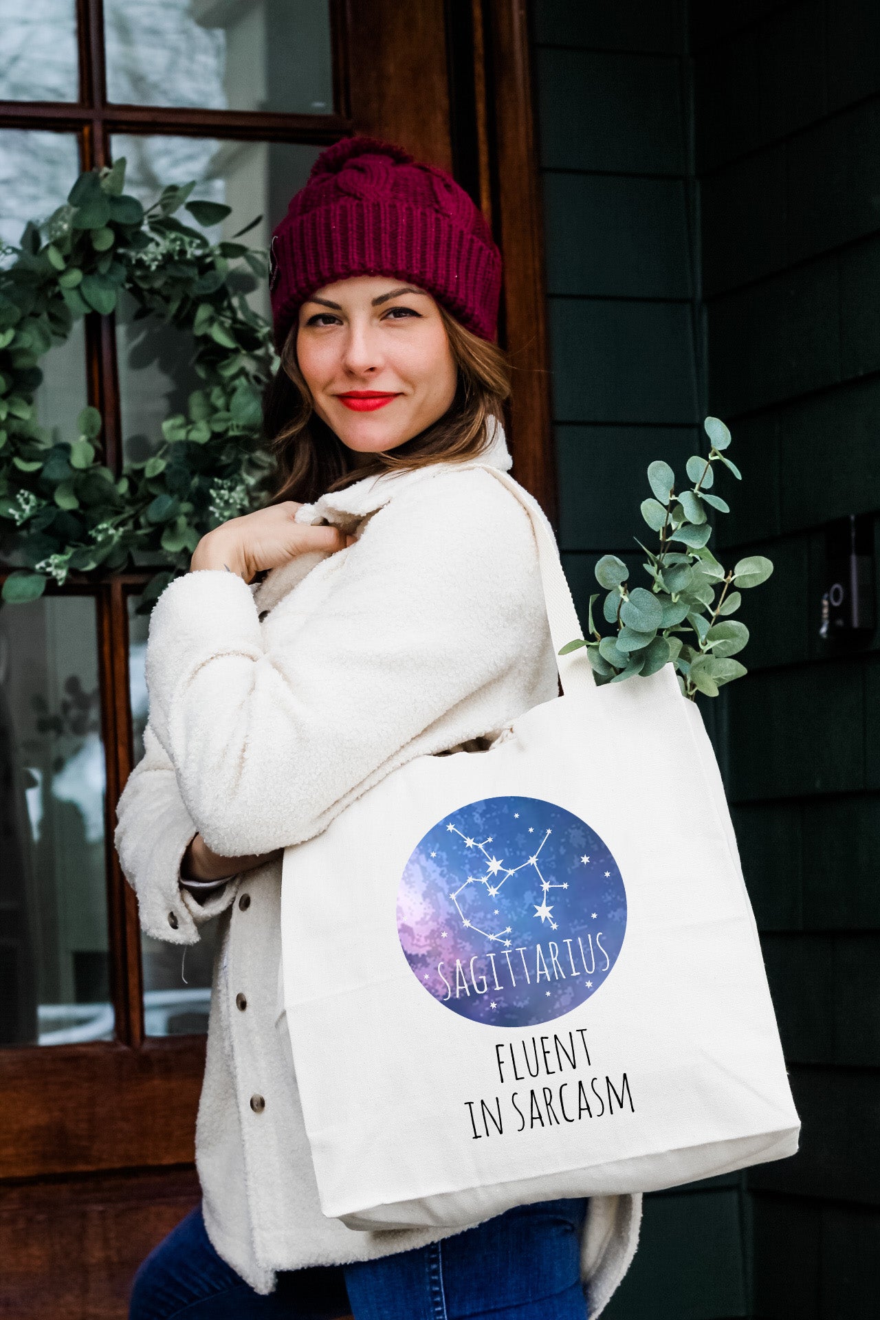 a woman carrying a white bag with a star sign on it