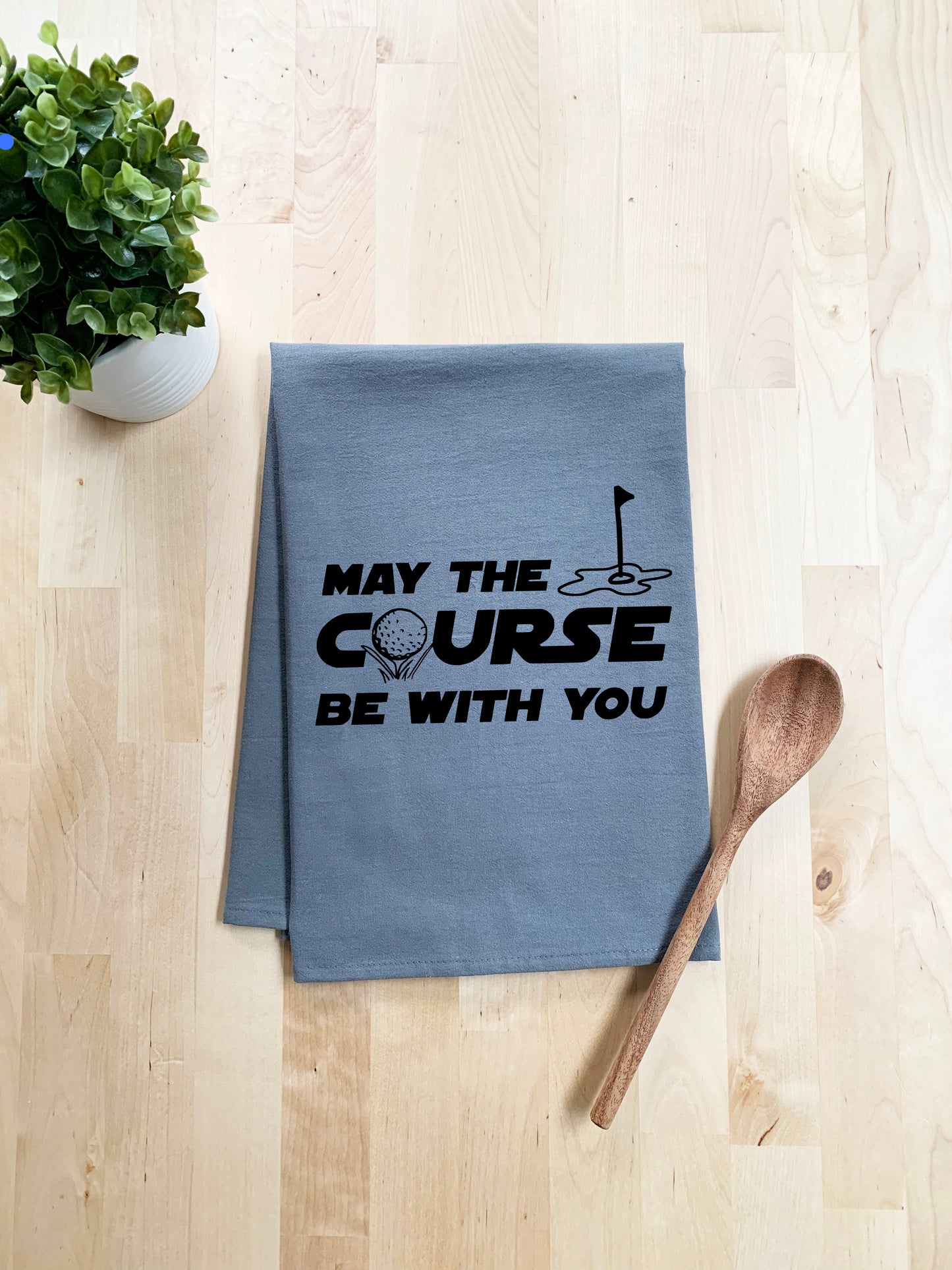 a tea towel that says may the course be with you