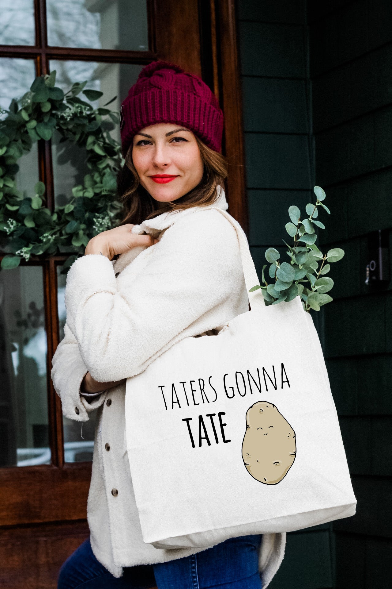 a woman carrying a bag with a potato on it
