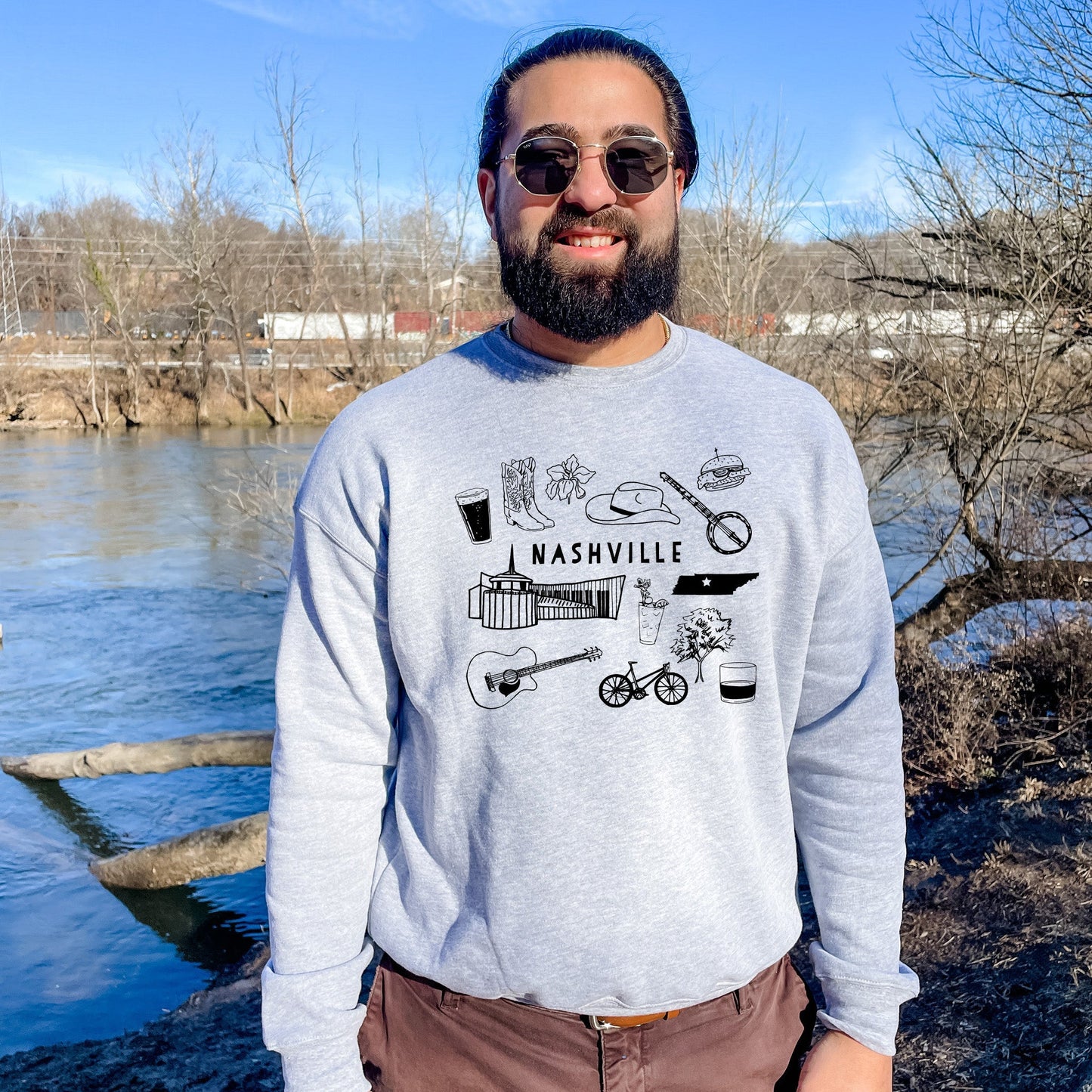 a man standing in front of a body of water