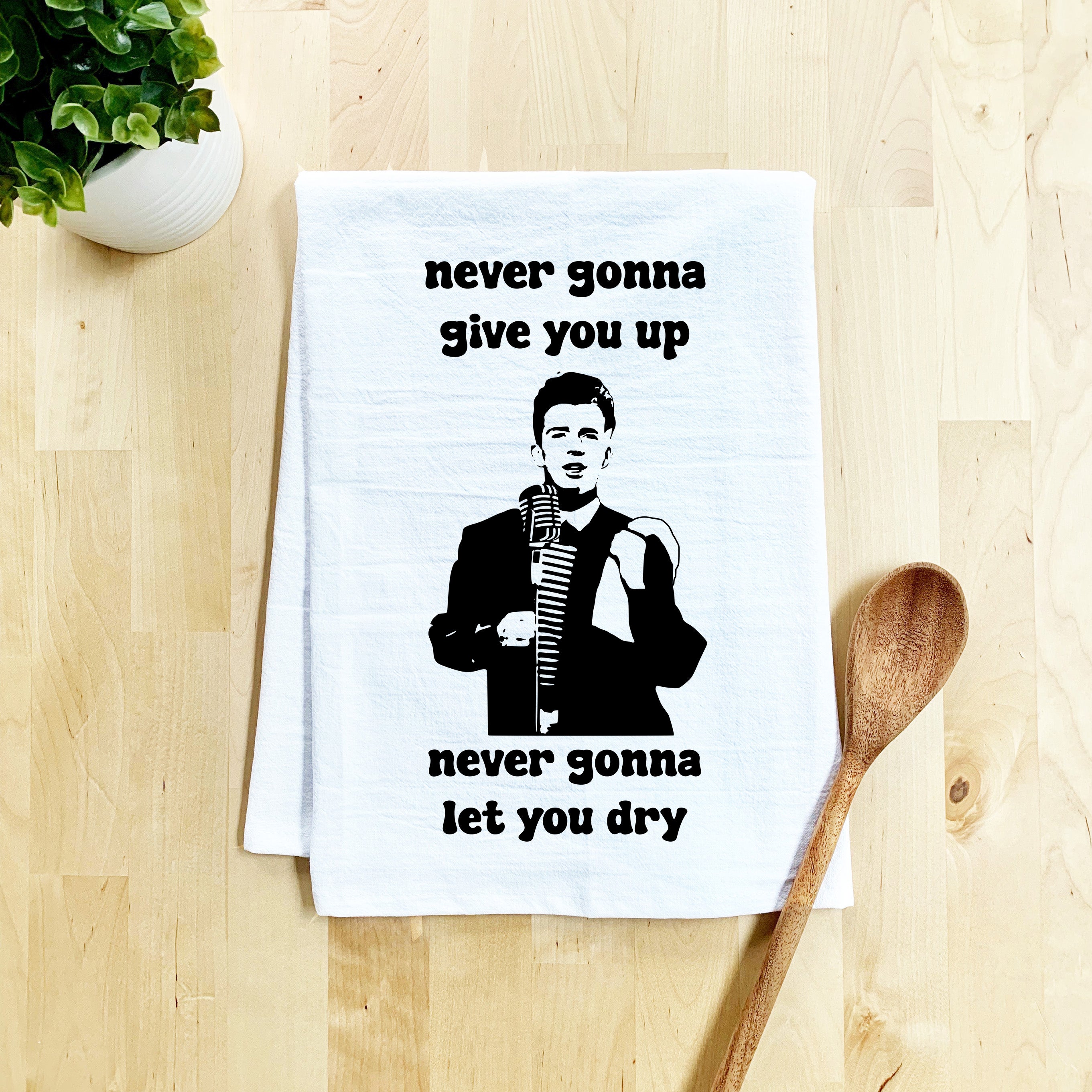 a tea towel with a picture of a man holding a microphone