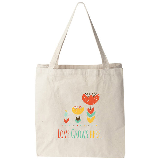 a tote bag that says love grows here