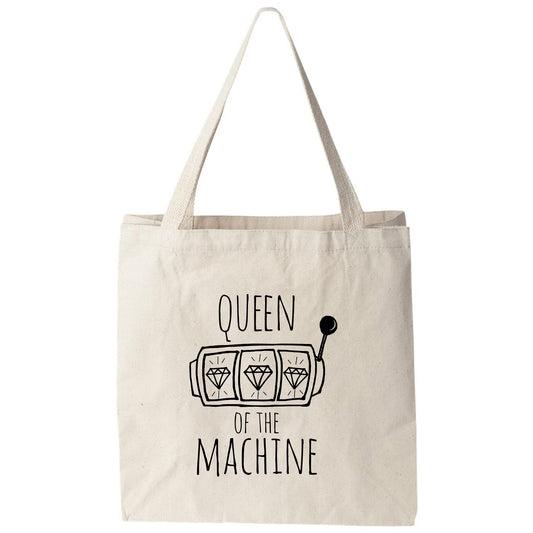 a tote bag that says queen of the machine