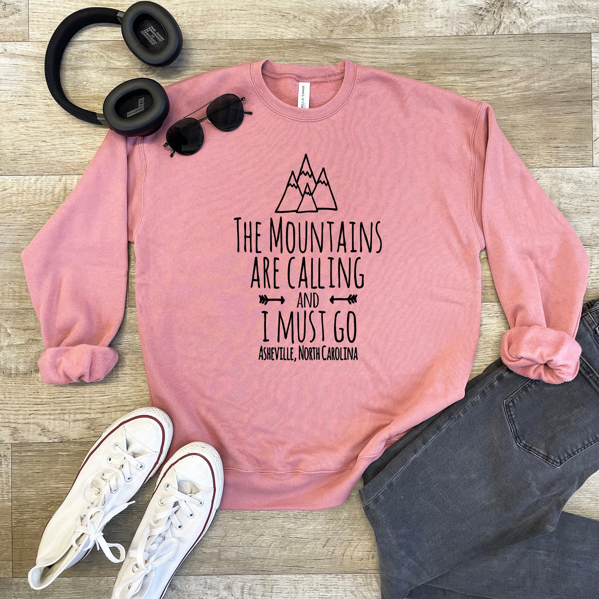 a pink sweatshirt that says the mountains are calling and i must go