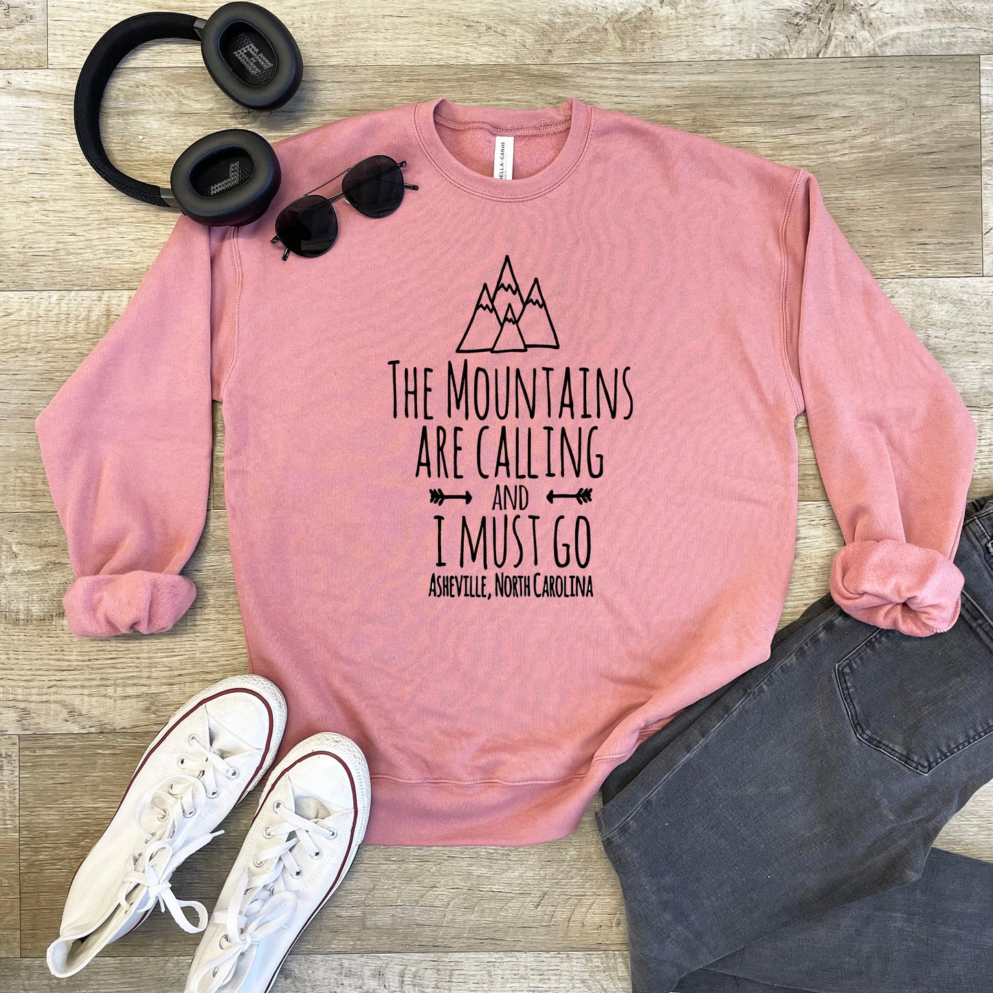 a pink sweatshirt that says the mountains are calling and i must go