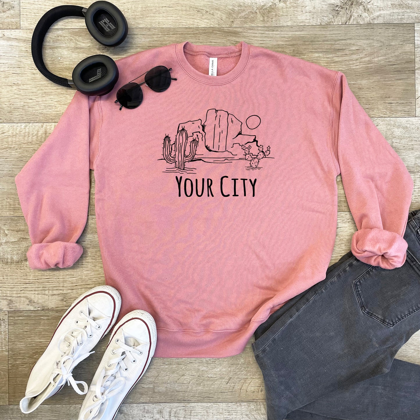 a pink sweatshirt with the words your city printed on it